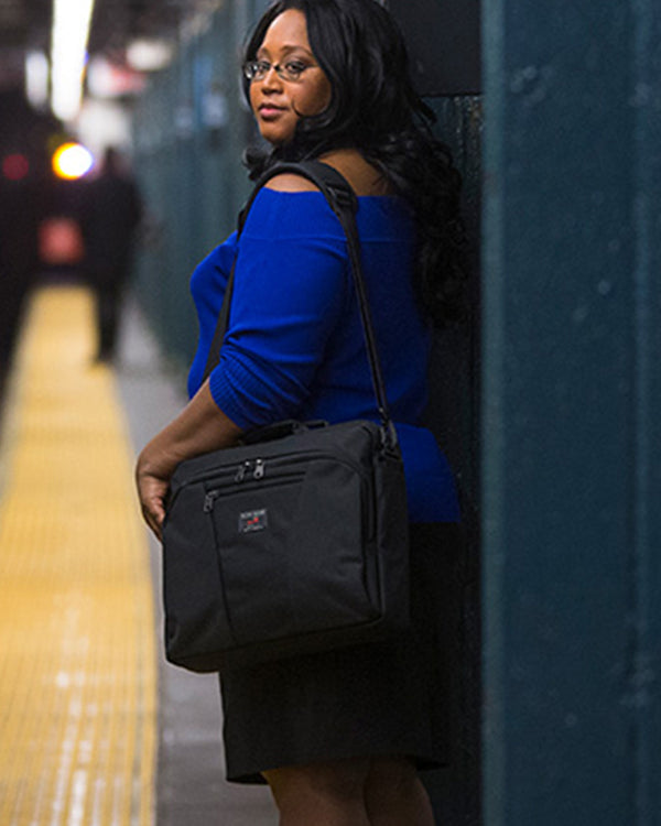 A person waiting for the light rail wearing a Cadet.